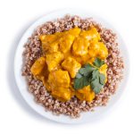 Buckwheat with chicken curry sauce isolated on white background.