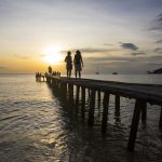 Tourists on pier watching at sunset, Koh Rong, Koh Kong province, Cambodia
